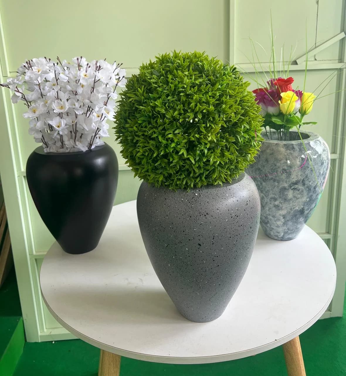 Black, speckled grey, and marble-effect planters