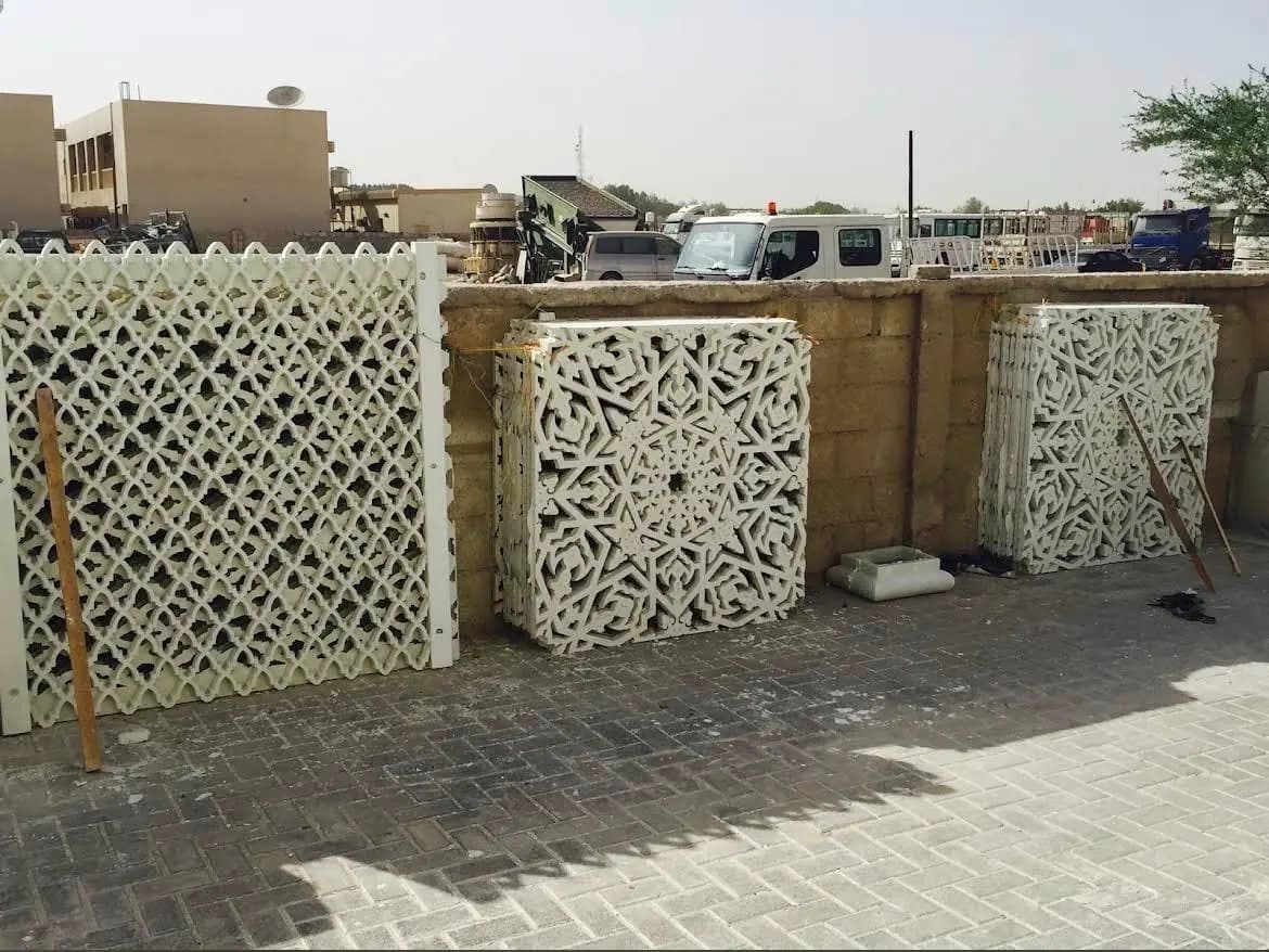White geometric screen panels standing in a yard
